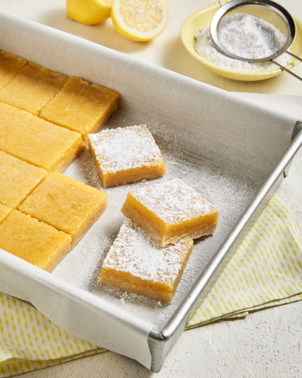 Des barres au citron saupoudrés de sucre à glacer Redpath servies sur une plaque métallique 